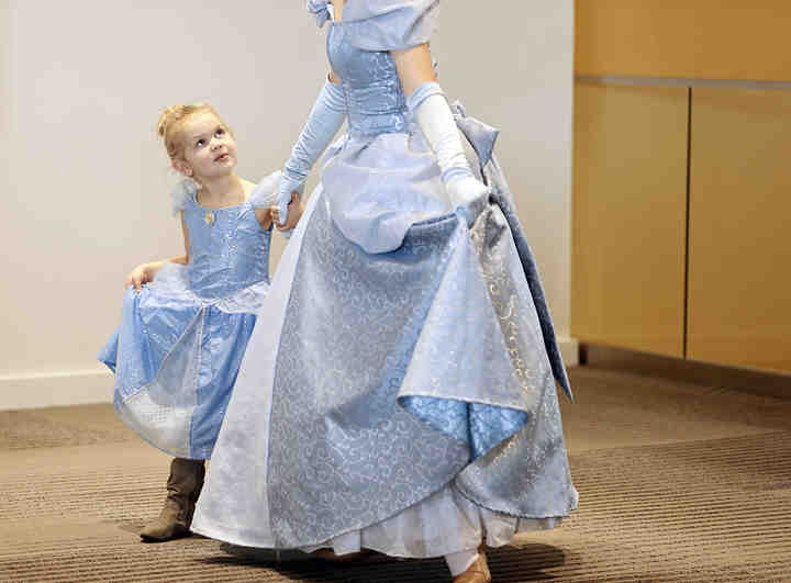 Dressed as Cinderella, Teegan Gecsvich, 4, of Marysville, gets tips on her curtsy from a similarly dressed princess during a sold-out Princess Party at the Greater Columbus Convention Center.  (Barbara J. Perenic / The Columbus Dispatch)